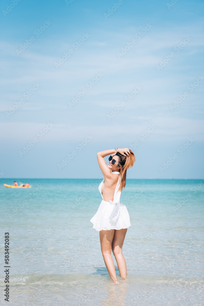Portrait of beautiful young asian woman on the beach, relaxing time on vacation summer at the blue sea. Portrait of beautiful young asian woman on the beach, relaxing time on vacation summer at the blue sea.
