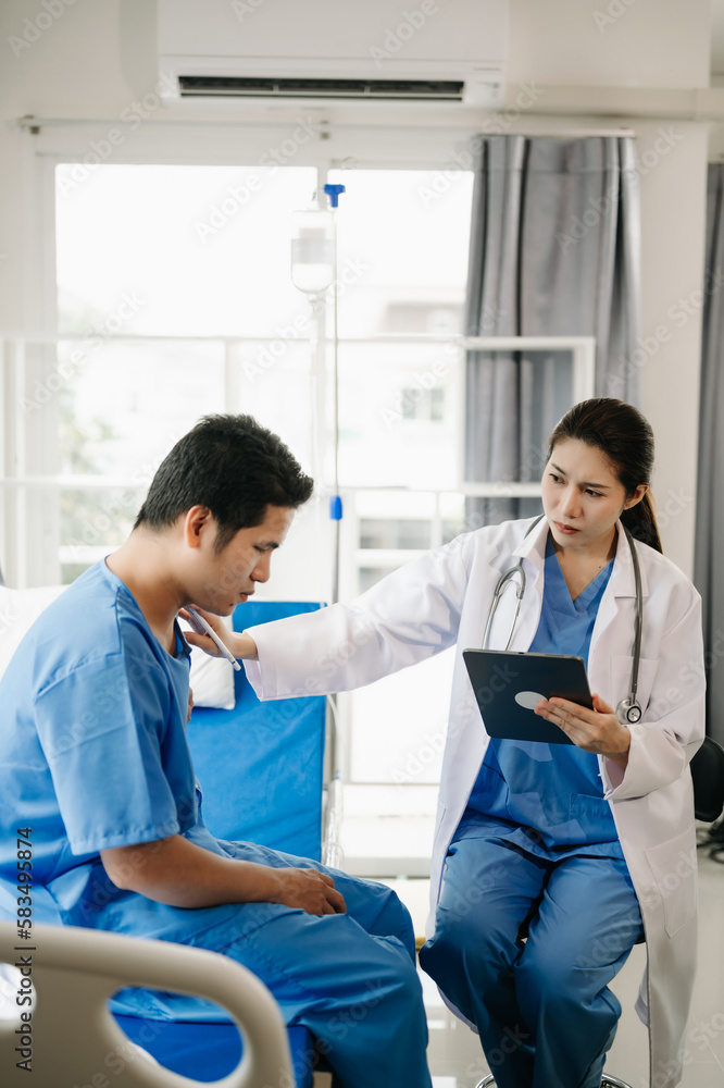 Fototapeta premium Asian doctor in white suit take notes while discussing and Asian elderly, man patient who lying on bed with receiving saline solution in hospital. .