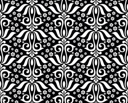 Wallpaper in the style of Baroque. Seamless vector background. White and black floral ornament. Graphic pattern for fabric, wallpaper, packaging. Ornate Damask flower ornament