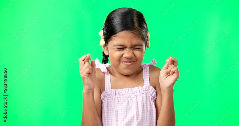 Child, wish and fingers crossed on green screen for luck or faith. Girl kid or eyes closed emoji for hope, praying and miracle or help on studio background space with mockup space while hopeful Child, wish and fingers crossed on green screen for luck or faith. Girl kid or eyes closed emoji for hope, praying and miracle or help on studio background space with mockup space while hopeful