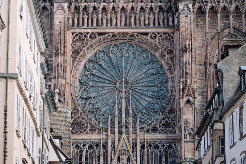 Naklejka premium Front facade of the Strasbourg Cathedral with its rose window. G. Othic architecture 