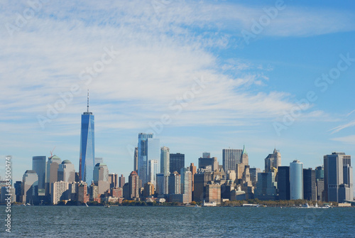 Gorgeous view of the Manhattan skyline with the Freedom Tower over a calm sea on a sunny day