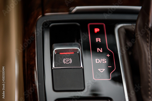 Electronic handbrake button. Gear shift stick into P position, (parking) symbol in automatic transmission car. Modern automatic gearbox car. Car detailing. Interior car inside. Car handle closeup.