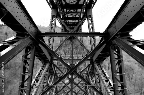 Steel construction of the very high historical railway Bridge “Müngstener Brücke“ between Solingen and Remscheid Germany from below the railroad track. Symmetrical view  contrasting black and white. photo