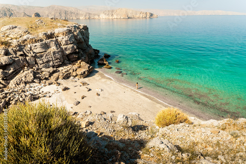Aerial view tourist woman in bikini walk on white sand beach alone in persian gulf Mirellas island. Musandam.Oman photo