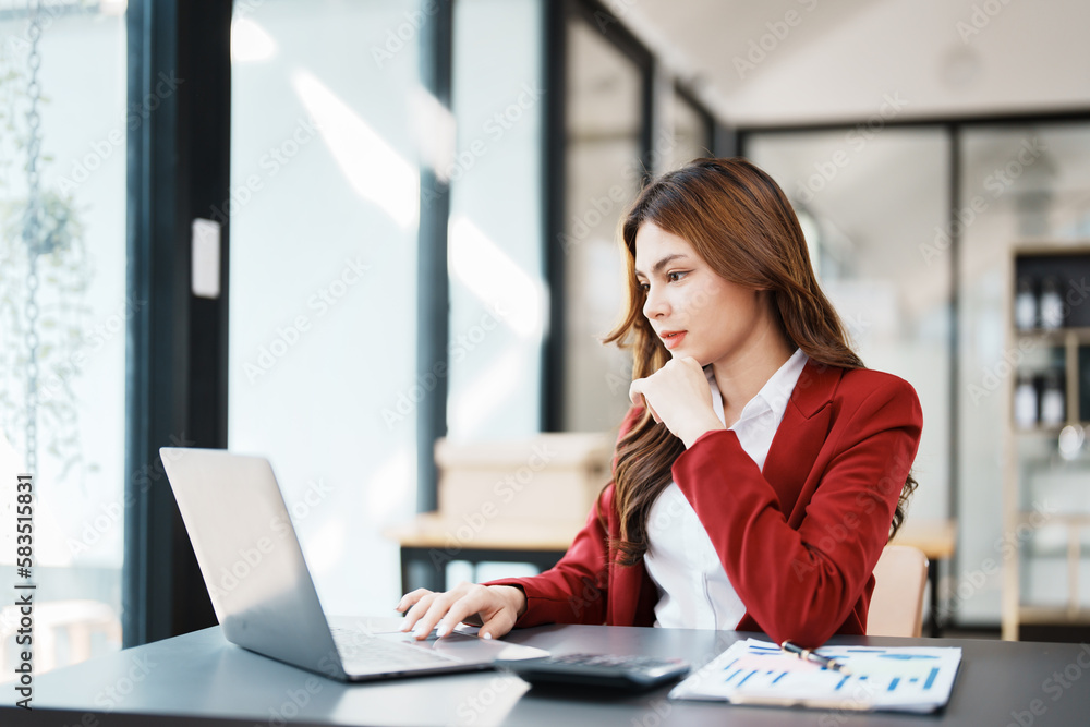 Beautiful young teen asian businesswoman using computer laptop and calculator for calculate with planning working on financial document, tax, exchange, accounting and Financial advisor Beautiful young teen asian businesswoman using computer laptop and calculator for calculate with planning working on financial document, tax, exchange, accounting and Financial advisor