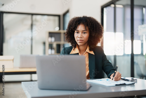 Beautiful young teen American African business woman thoughtful confused looking at laptop computer, Stress while reading report or email. Online marketing problem, finance mistake, troubleshooting