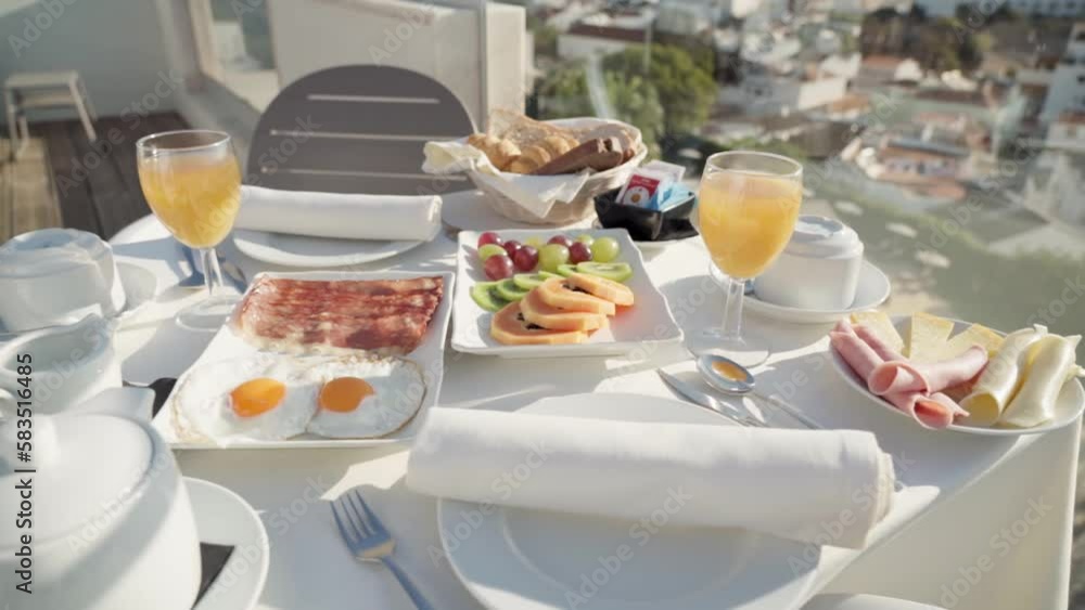 Tasty and healthy breakfast of bacon eggs and other ingredients on the hotel terrace close-up. Tasty and healthy breakfast of bacon eggs and other ingredients on the hotel terrace close-up.