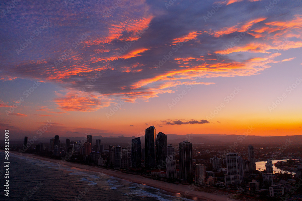 Colouful aerial sunset view over Gold Coast skyline and beach	