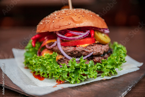 Healthy burger vegan and nonvegan style food dish. Restart burger sets on wooden plate. Meaty juicy burgers with vegetables. Culinary made dish. closeup shot and wide shot. Ham. Unhealthy junk food. 