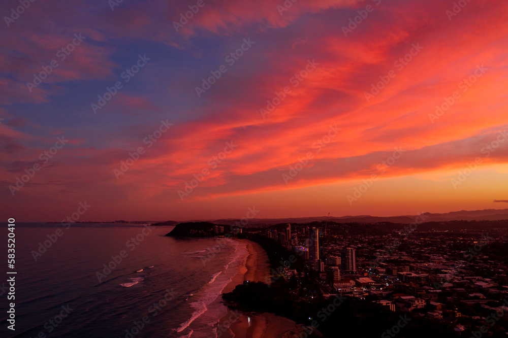 Sunlit pink clouds over Miami Hill with Burleigh in the horizon. Gold Coast, Australia