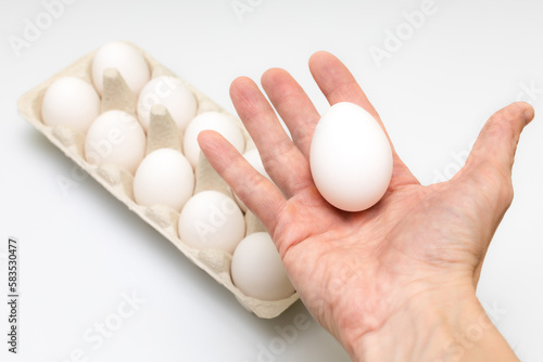 man holding a chicken egg in his hand