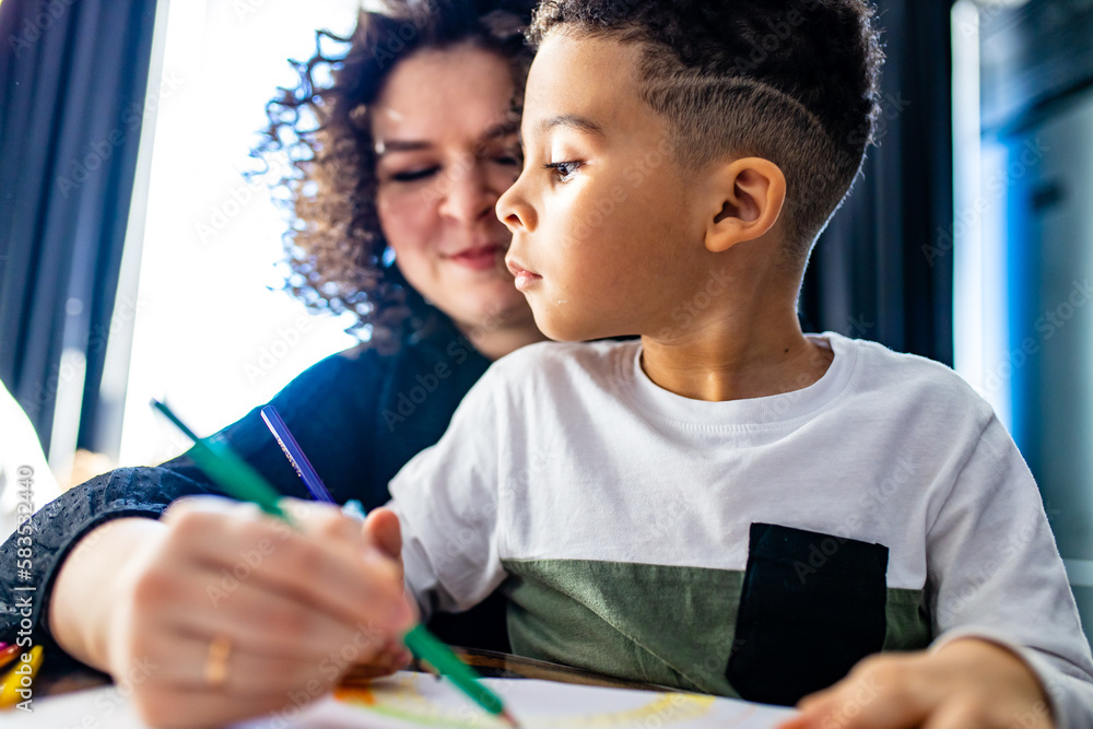 authentic afro hair curly woman and baby boy are painting draw on table day light background authentic afro hair curly woman and baby boy are painting draw on table day light background