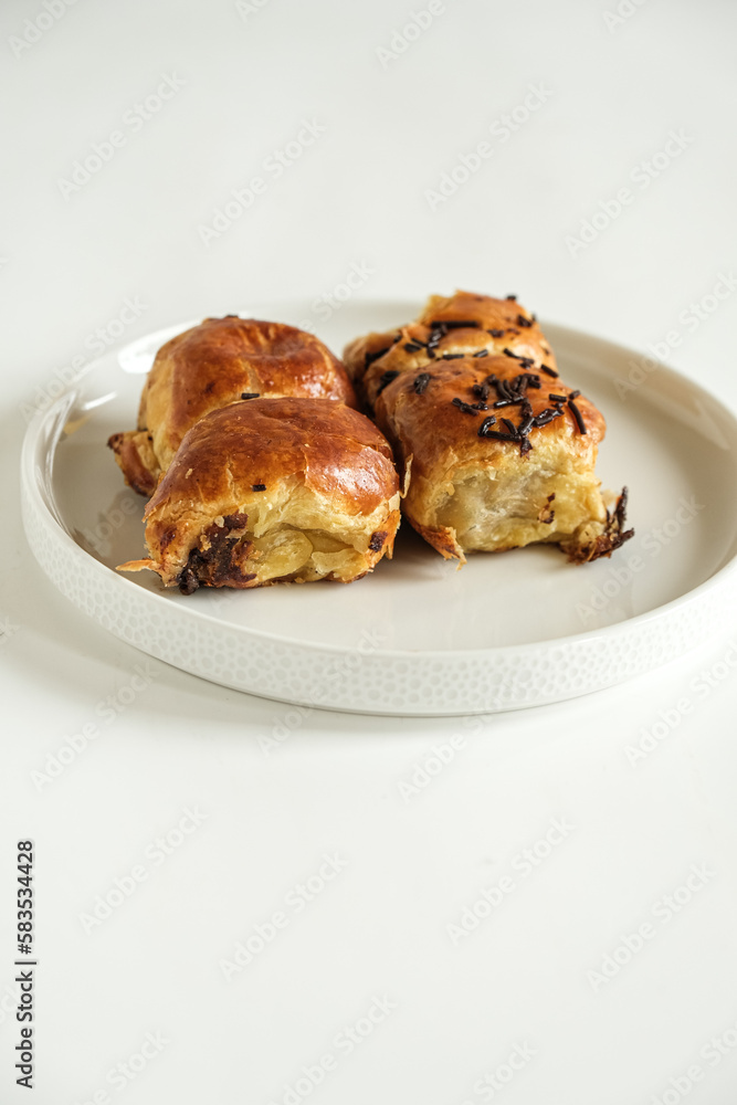 pisang bolen is made from bananas covered in rolled sheet of pasrty dough. various topping such as cheese and chocolate. selective focus pisang bolen is made from bananas covered in rolled sheet of pasrty dough. various topping such as cheese and chocolate. selective focus