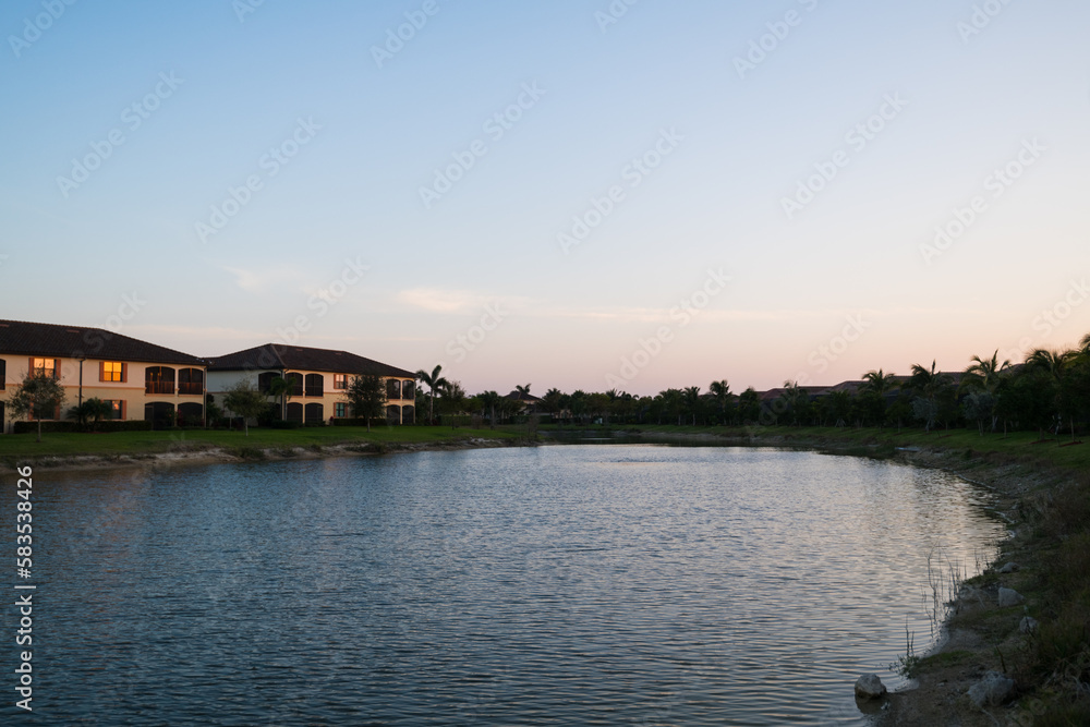 Condo buildings along the pond in a Bonita Springs private golf neighborhood. Real estate investment background