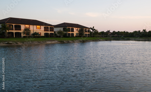 Sunset over the pond in a South Florida golf community with condos for sale.