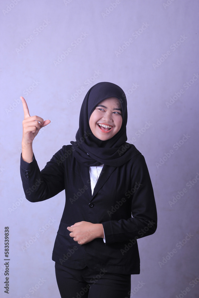 A woman in a black suit points her finger at the camera. A woman in a black suit points her finger at the camera.