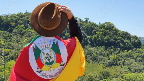 Person with hat and flag of the state of Rio Grande do Sul - Southern Brazil. Nature background.