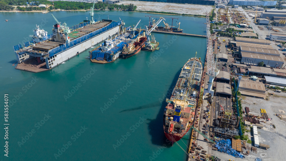 Oil tanker ship at dry dock concept maintenance service. working at dry dock. Insurance and Maintenance Crude tanker Ship concept. Freight Forwarding Service maintenance Insurance