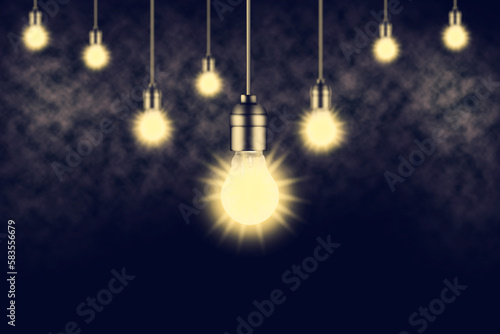 Dark background with glowing light bulbs and smoke.Copy space.
