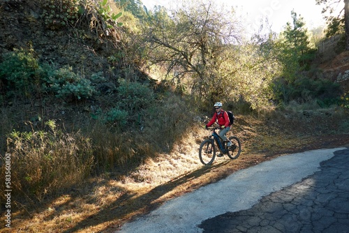 View of the biker cycling in the mountains on a sunny day