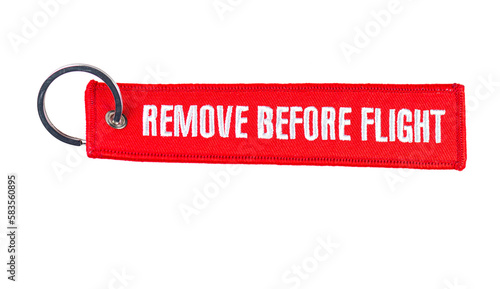 Fotografi Trinket Remove before flight - warning tag