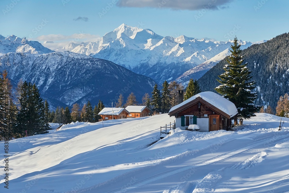 Landscape view of the small huts nestled between the snowy mountains