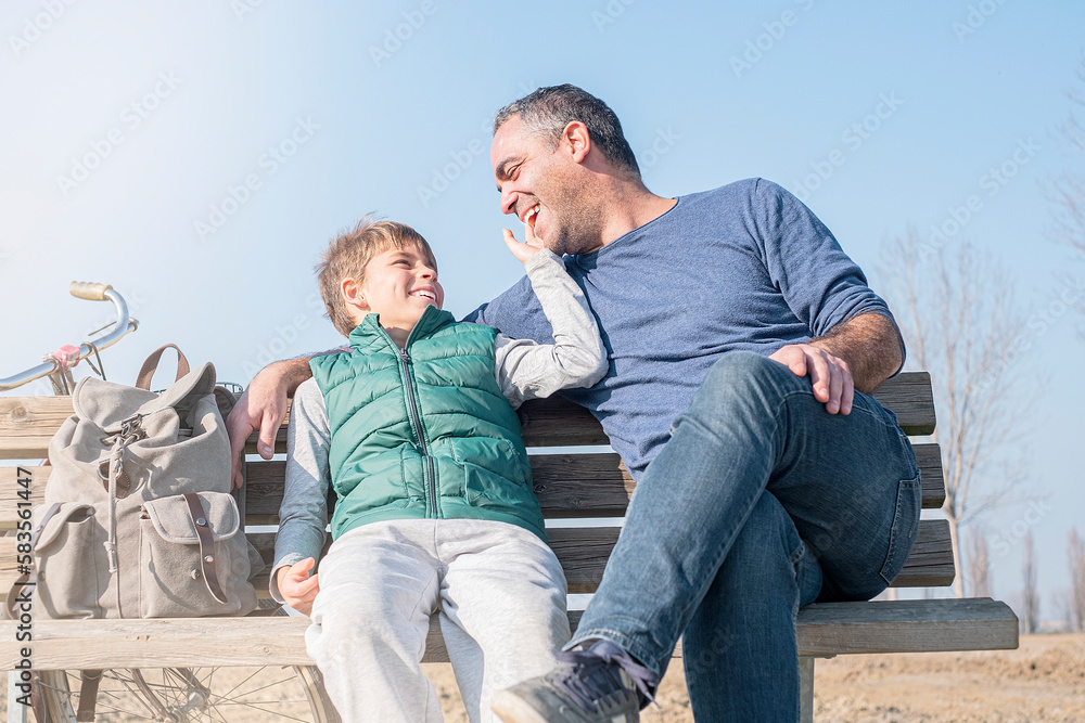 Happy smiling father and son against the blue sky Happy smiling father and son against the blue sky