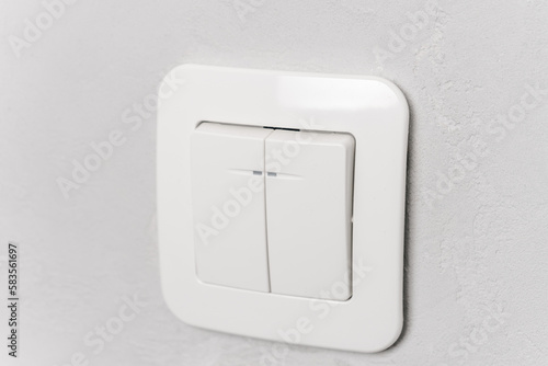 Obraz na plátně white plastic light switch on grey wall