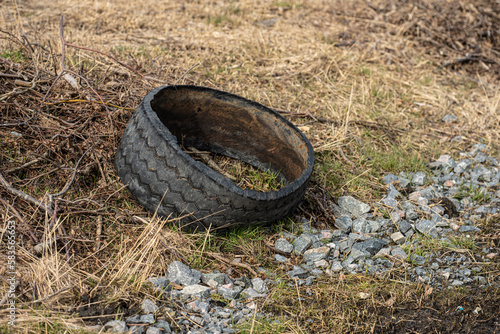 Delaminated truck tire in a ditch by a road. photo