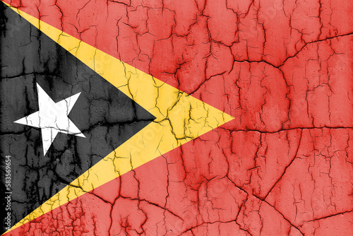 Flag of East Timor on cracked wall, textured background.