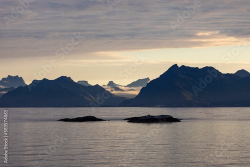 Beautiful aerial view of the hills at the shore at a calm sunrise