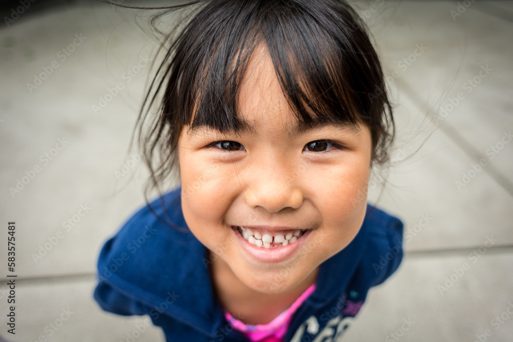 Young asian girl smiling with missing front tooth Young asian girl smiling with missing front tooth