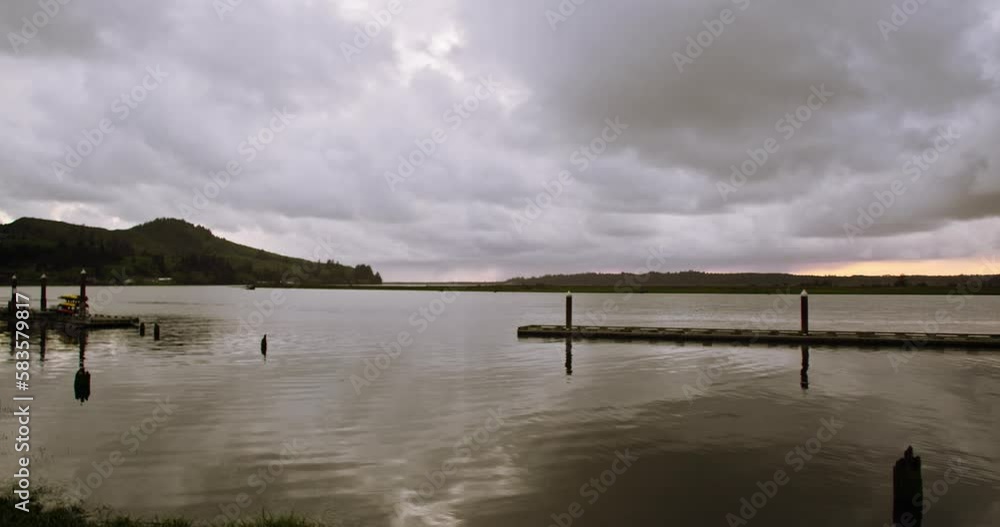 Motion of the lake with wooden piers under the cloudy sky on a gloomy day Motion of the lake with wooden piers under the cloudy sky on a gloomy day