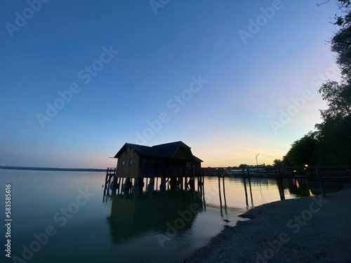 Beautiful shot of an overwater bungalow on stilts, during the blue-hour