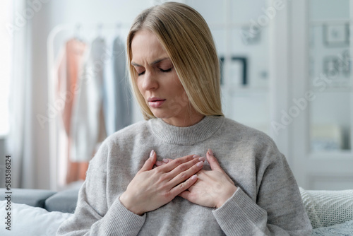 Tableau sur toile portrait of woman suffering from chest pain indoors