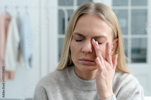 exhausted woman rubbing dry irritable eyes, closeup photo