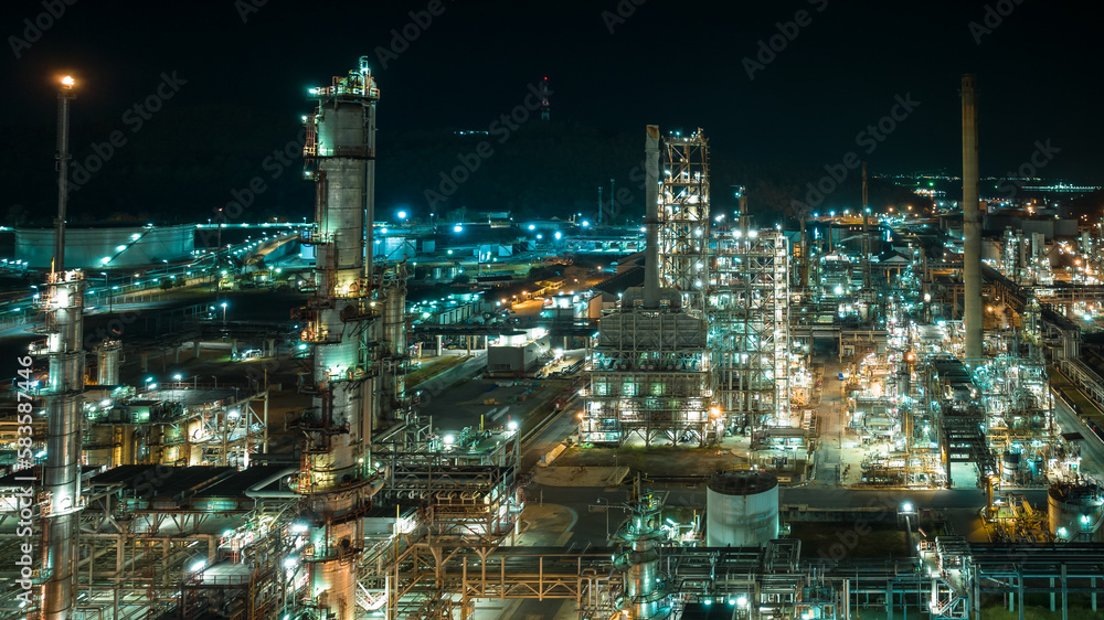 cityscape night scene shot oil storage tank  and oil refinery factory zone, global business and industry about natural resources wasteful for transportation and trading, aerial view