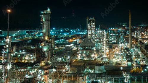 cityscape night scene shot oil storage tank  and oil refinery factory zone  global business and industry about natural resources wasteful for transportation and trading  aerial view
