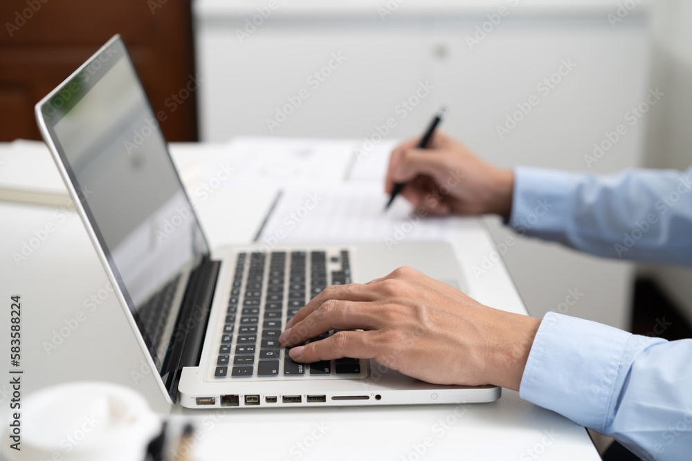 Business man working by using laptop computer Hands typing on a keyboard. Professional investor working new start up project. business planning in office. Technology business Business man working by using laptop computer Hands typing on a keyboard. Professional investor working new start up project. business planning in office. Technology business