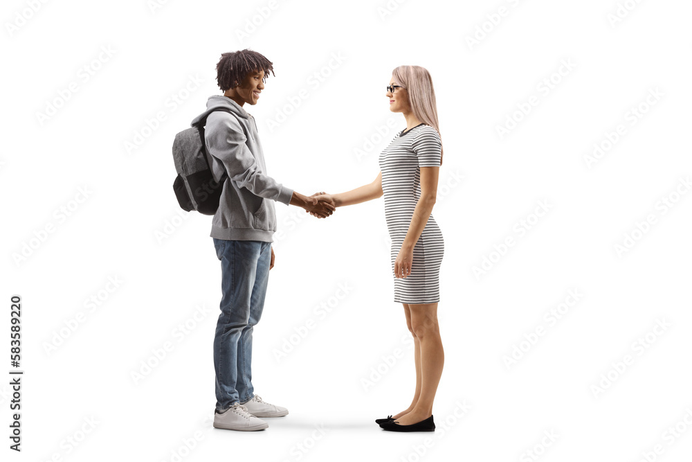 Full length profile shot of an african american young man  shaking hands with a young caucasian woman