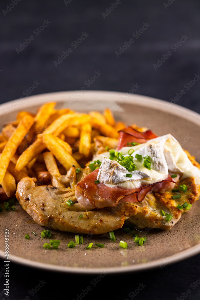 typical czech cuisine chicken slice baked with ham and camembert with french fries