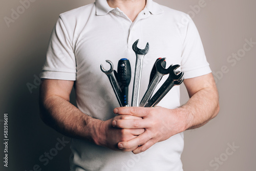 Man with bouquet of wrenches  spanners and screwdrivers. Father s Day concept