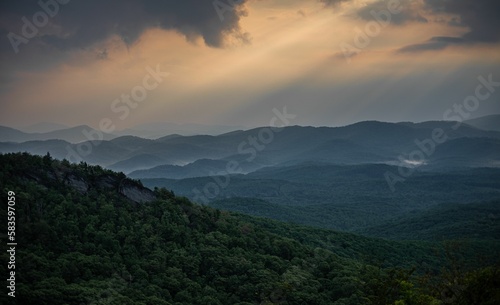 Aerial view of blue Ridge mountain landscape surrounded by dense trees during sunset © Walker Winslow/Wirestock Creators