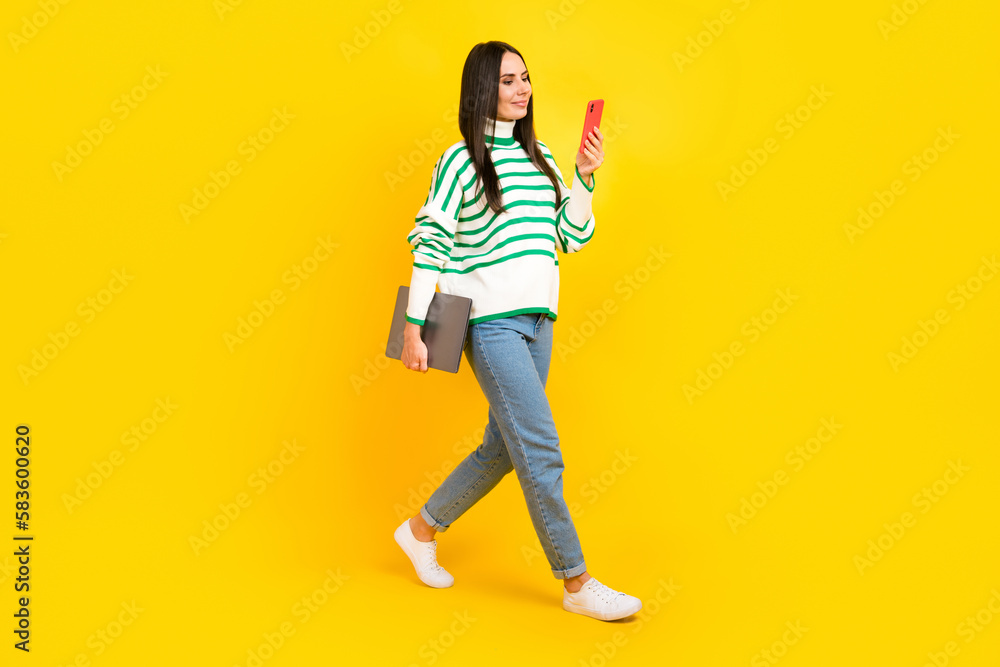 Full length photo of busy successful lady use modern device going work empty space isolated on yellow color background Full length photo of busy successful lady use modern device going work empty space isolated on yellow color background