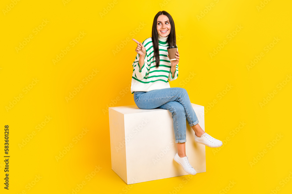 Full length photo of positive glad lady hold aromatic delicious drink presenting opening new cafe isolated on yellow color background Full length photo of positive glad lady hold aromatic delicious drink presenting opening new cafe isolated on yellow color background