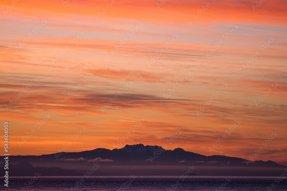 Aerial view of beautiful mountains near the ocean in Vancouver, Canada at sunset Aerial view of beautiful mountains near the ocean in Vancouver, Canada at sunset