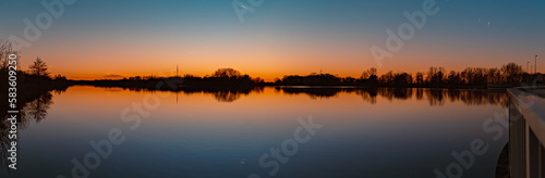 High resolution stitched sunset panorama with reflections near Plattling, Isar, Bavaria, Germany