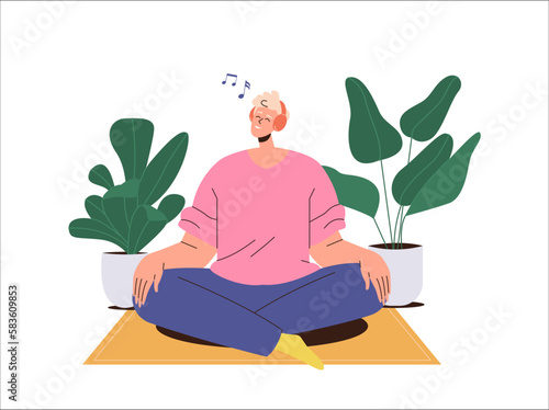 Happy smiling guy wearing wireless earphones headset listening to music sitting on floor at home