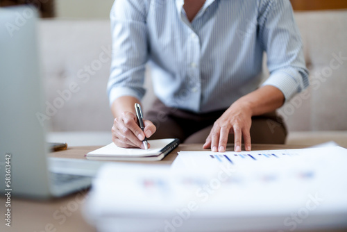 Woman calculating monthly expenses, taxes and interest calculate at home..